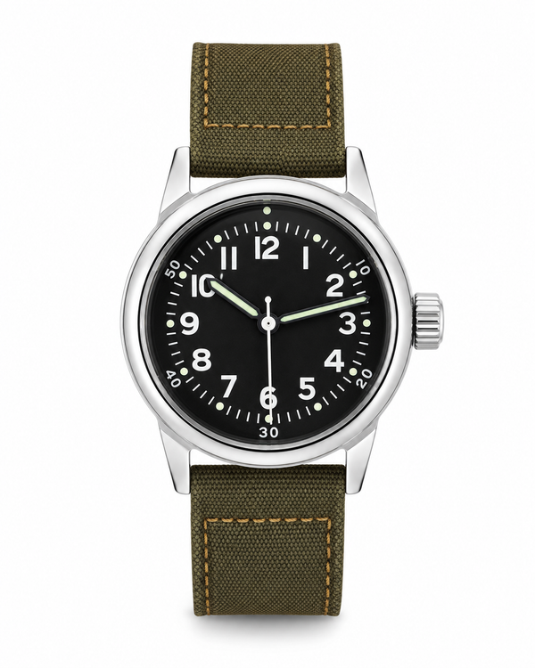 A wristwatch with a black dial, silver-tone case, and olive green canvas strap with tan stitching, shown on a plain white background.