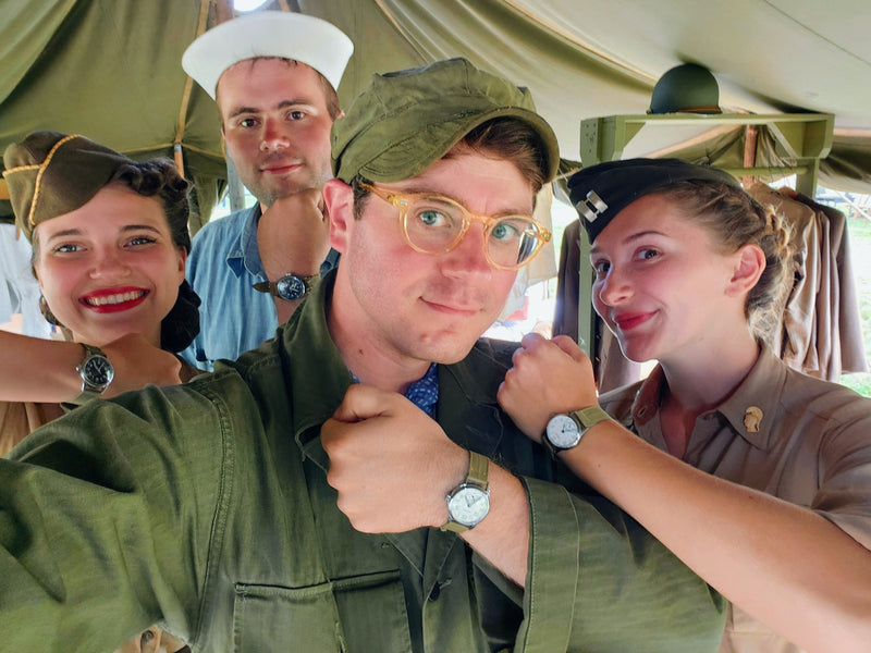 A photograph of four people in vintage WWII uniforms wearing Timeworn Watches