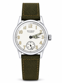 A Whitman 17 Jewels wristwatch with an olive green canvas strap and a silver-toned case, featuring a cream-colored dial with gold Arabic numerals and a small seconds sub-dial.