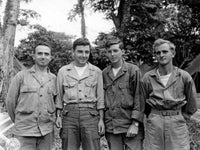 A historical photograph of Soldiers in the Pacific Theater wearing Ordnance Department watches while on duty.