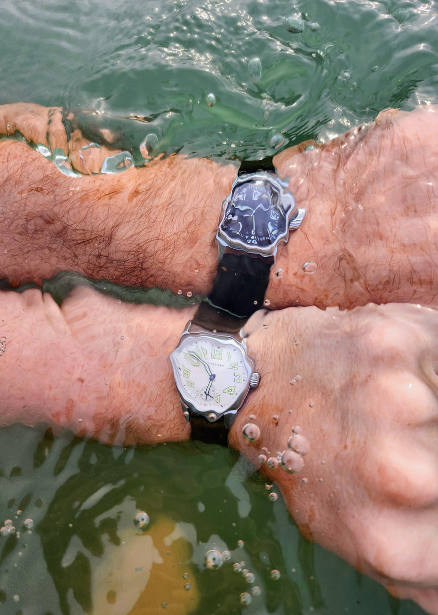 Durable Timeworn watches with green straps being worn under water